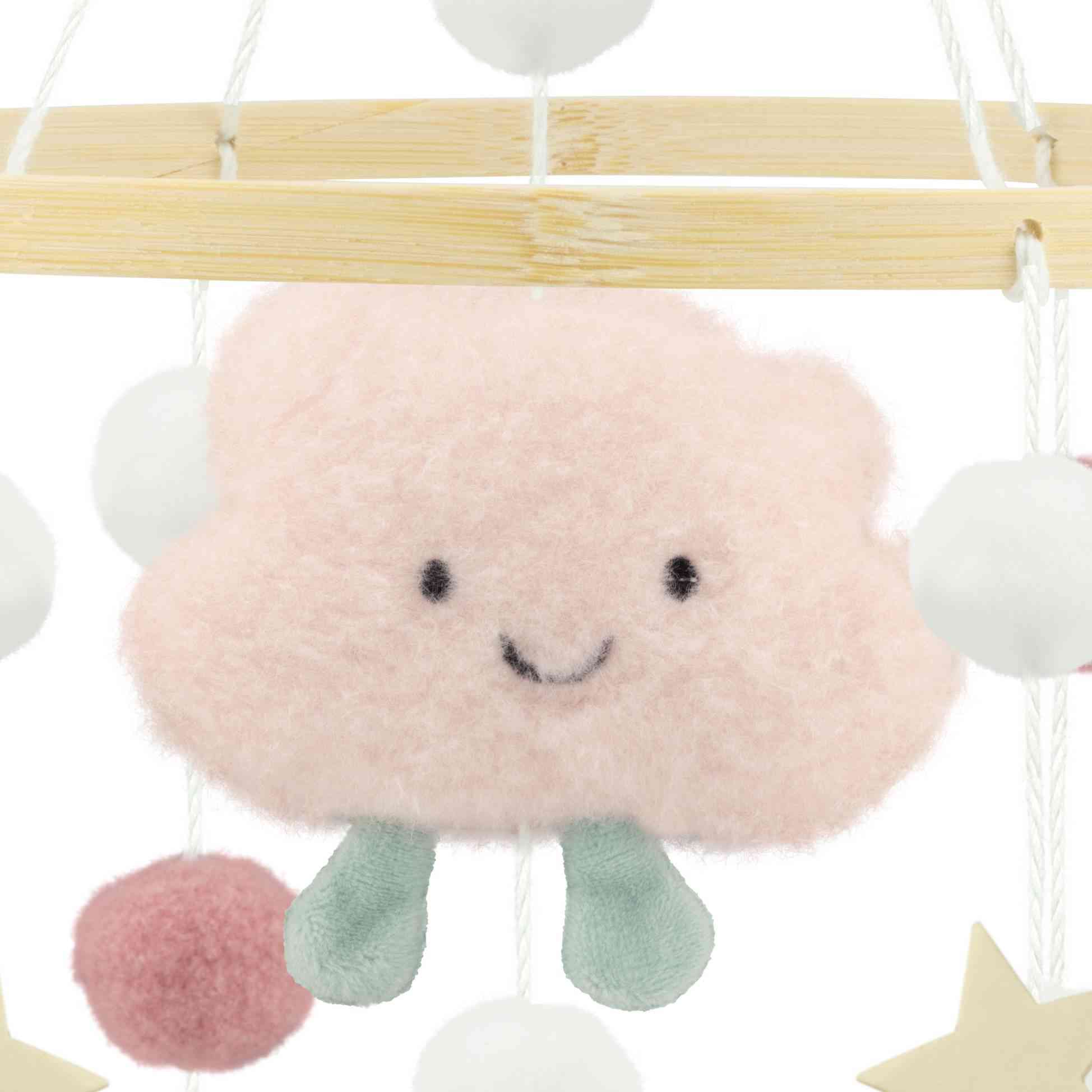 Ein Baby-Mobile mit einer flauschigen, rosa Plüschwolke mit einem fröhlichen Gesicht und kleinen blauen Beinen. Die Wolke ist von verschiedenen weißen, rosa und grauen Pompons umgeben, die an einem Holzrahmen hängen. Das Ulysse Couleurs d'Enfance - Mobile mit rosa Wolken von Ulysse Couleurs d'Enfance ist ein ideales pädagogisches Spielzeug ab 2, um die frühen Entwicklungsfähigkeiten der Kleinen zu fördern.